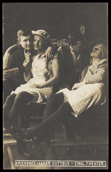 Download the full-sized image of Four British prisoners of war at a prisoner of war camp in Cottbus, posing as lovers. Photographic postcard, 191-.