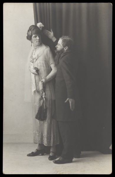 Download the full-sized image of Ralph Mellor in drag and another actor perform a scene in Trilby. Photographic postcard by L.S. Langfier, 192-.