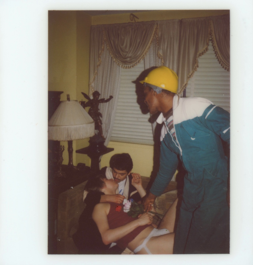 Download the full-sized image of A Photograph of Marsha P. Johnson Wearing a Construction Hat and Tracksuit, with Two Unknown People